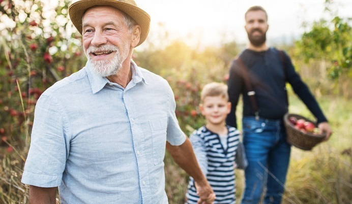 Three generations in apple orchard